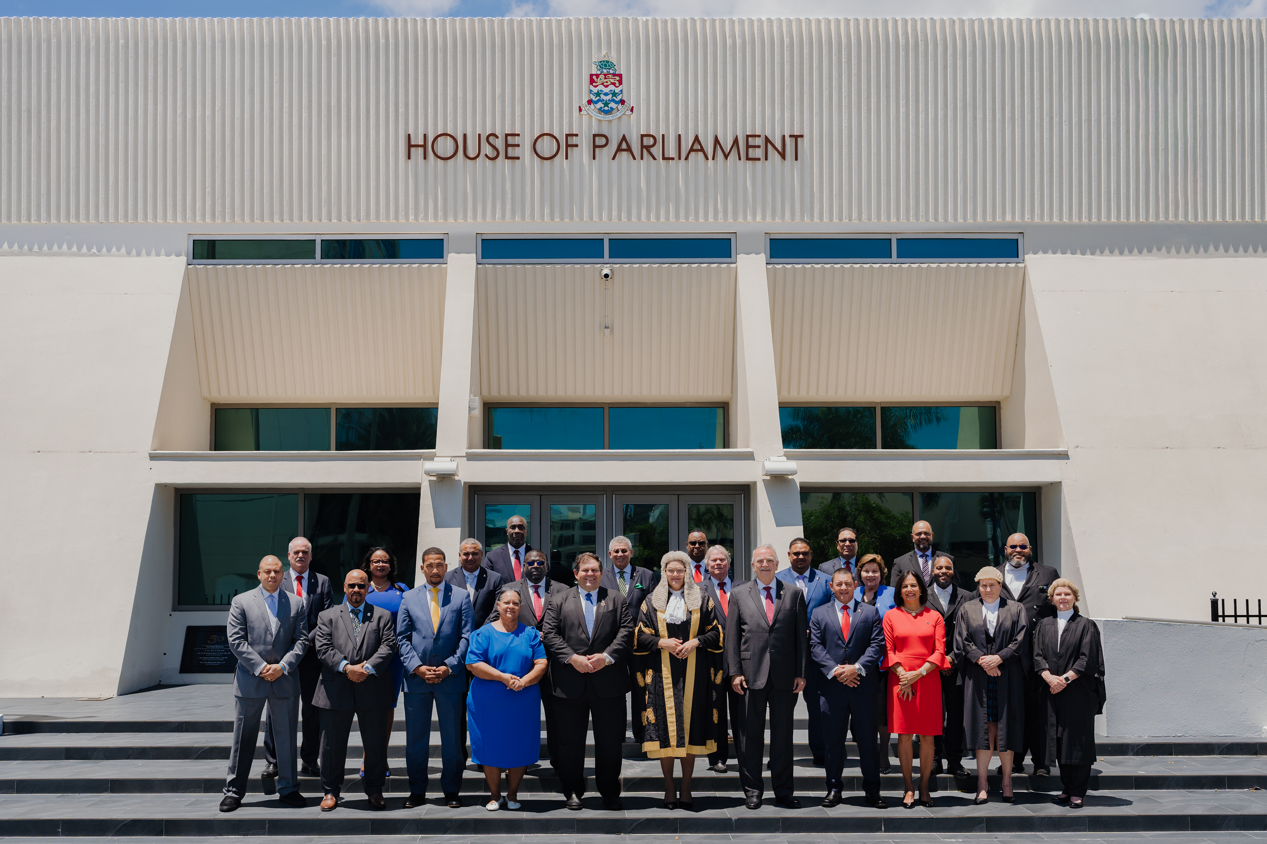 Group photo of the 2021-2025 Members of Parliament standing on the steps of the Parliament building.